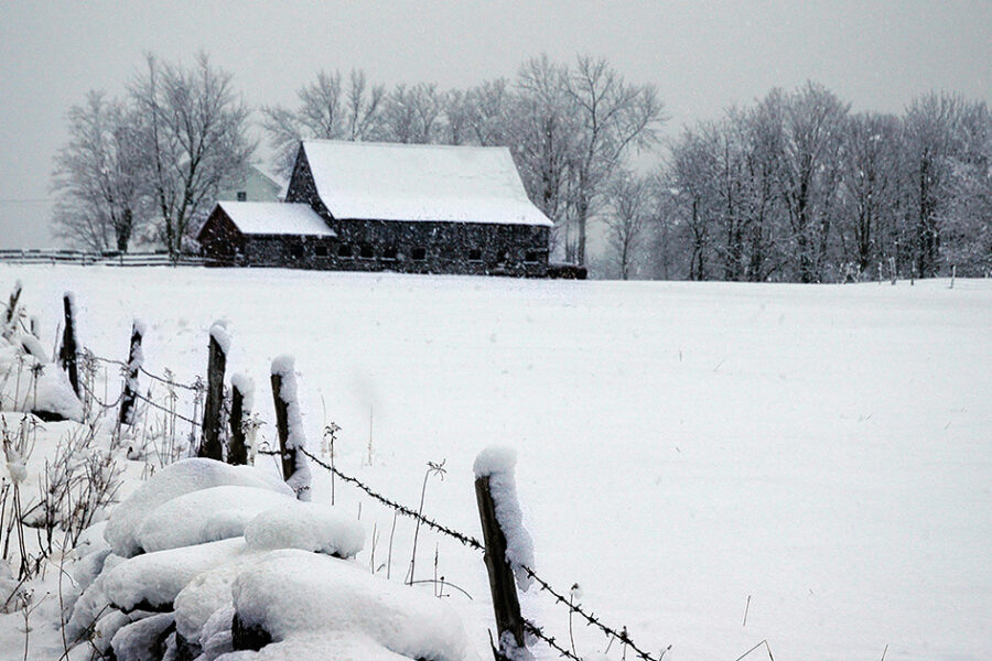 Photo of a barn in a snowy field