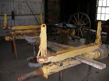 The frame of the wagon is set on jacks and saw horses.