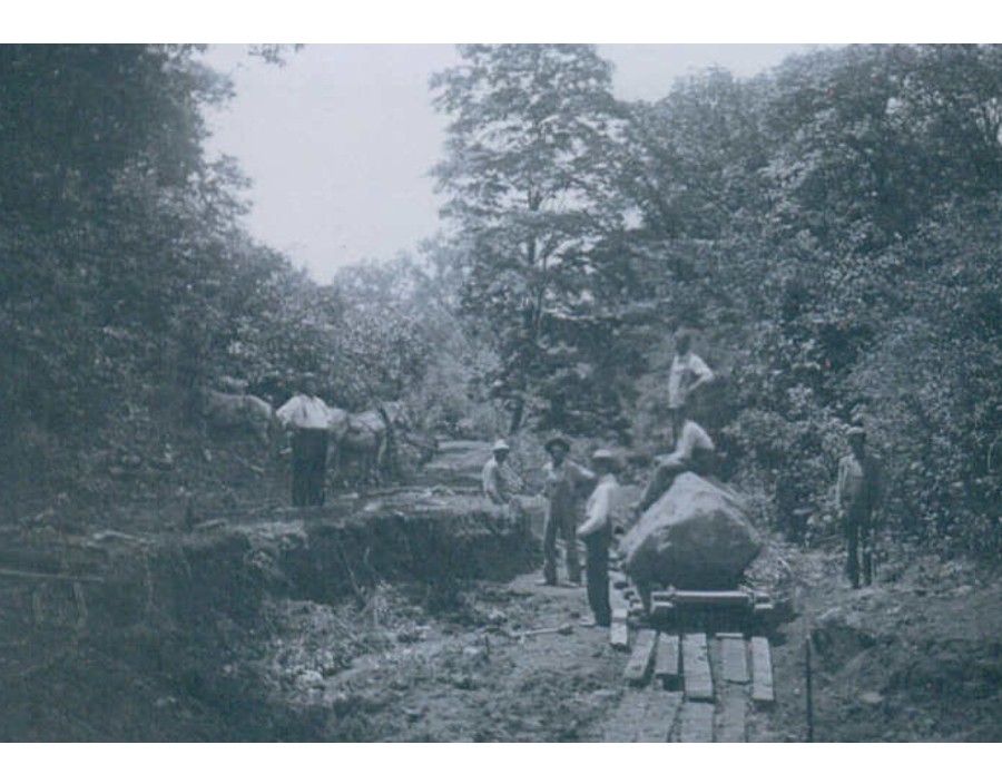 Workers moving the Lincoln-Douglas Park boulder