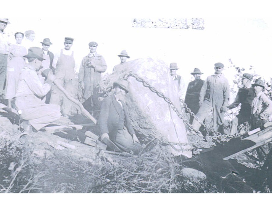 Workers moving the Lincoln-Douglas Park boulder